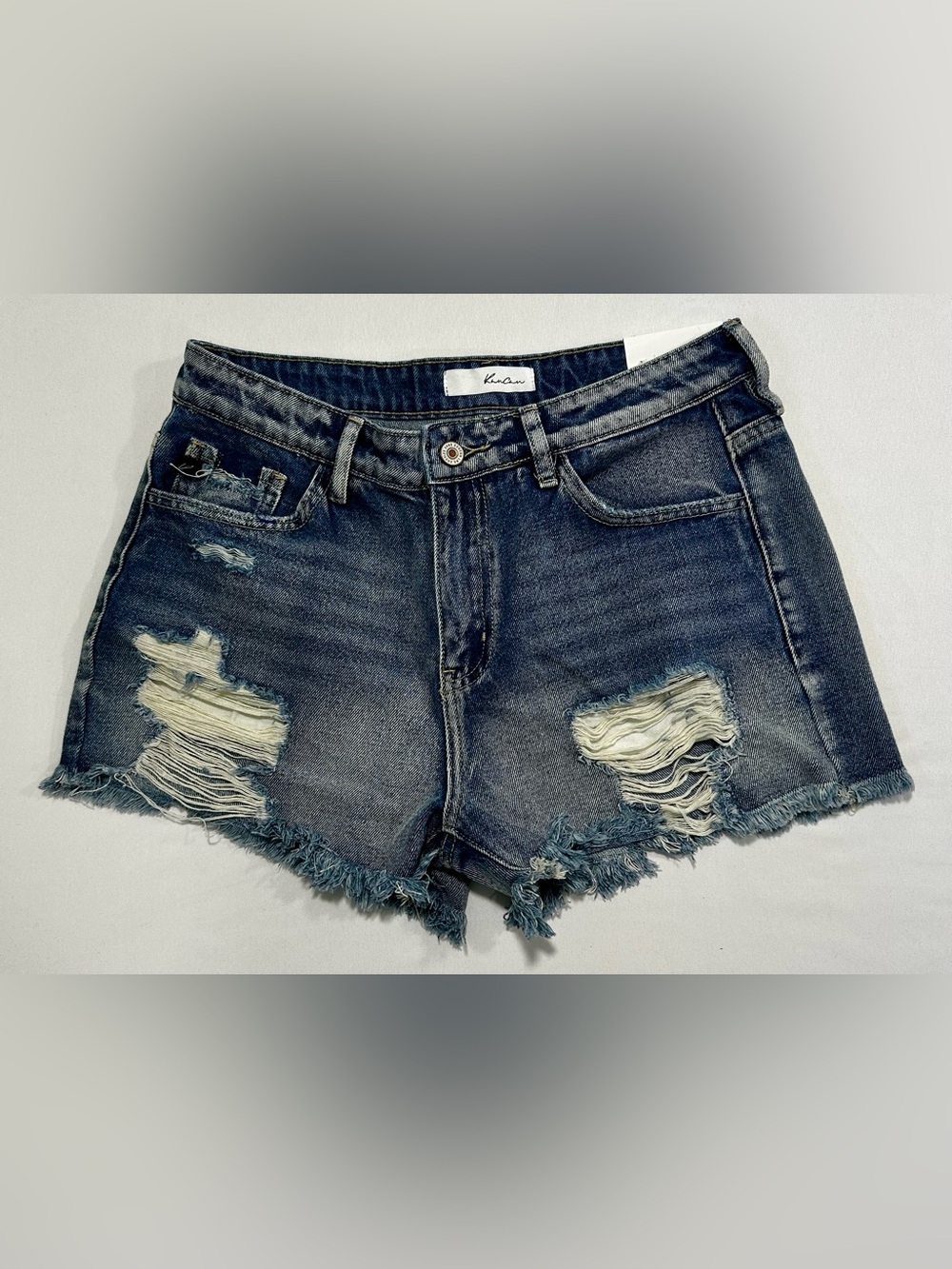 KanCan high-rise distressed denim shorts, medium wash, frayed hemline.
M/27